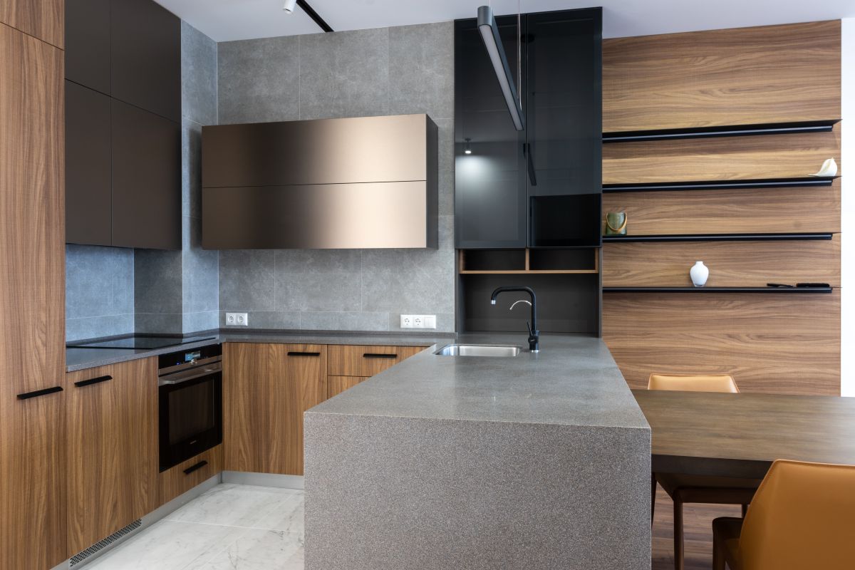 Wood-fronted kitchen cabinets beside a grey island