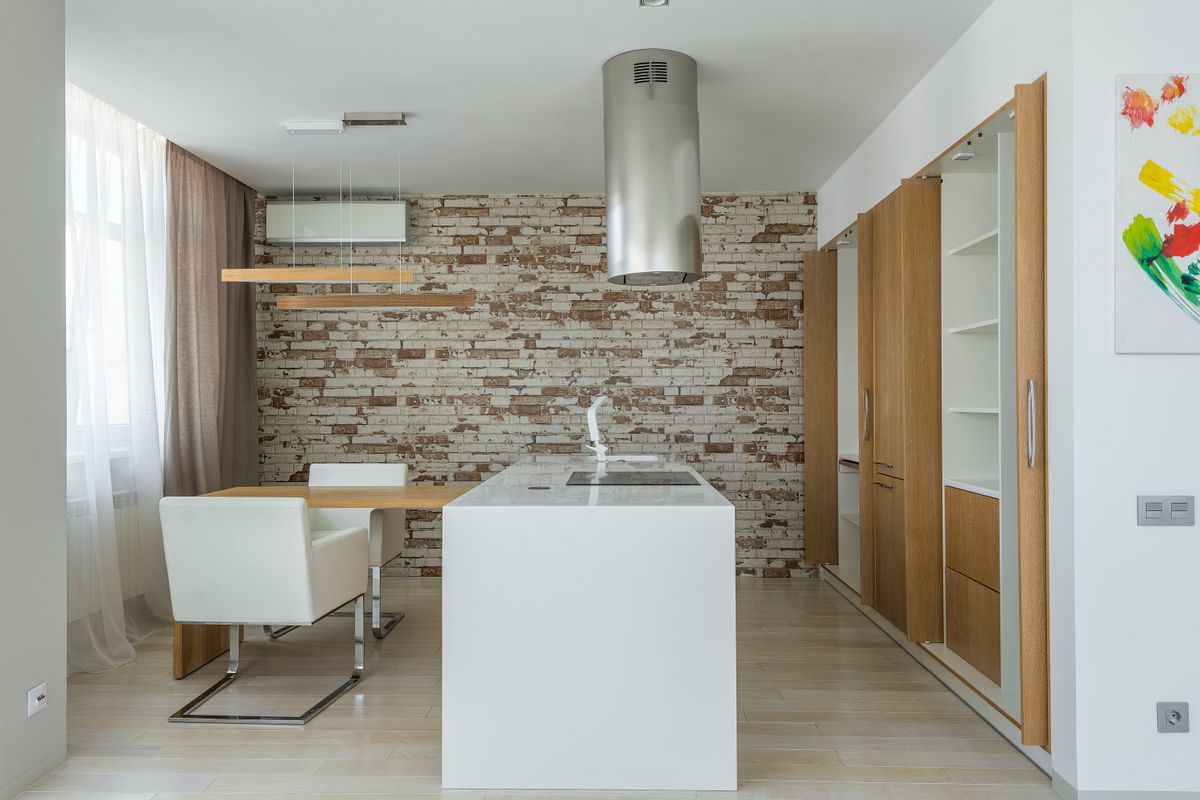 Light kitchen with a long worktop and wooden cabinetry