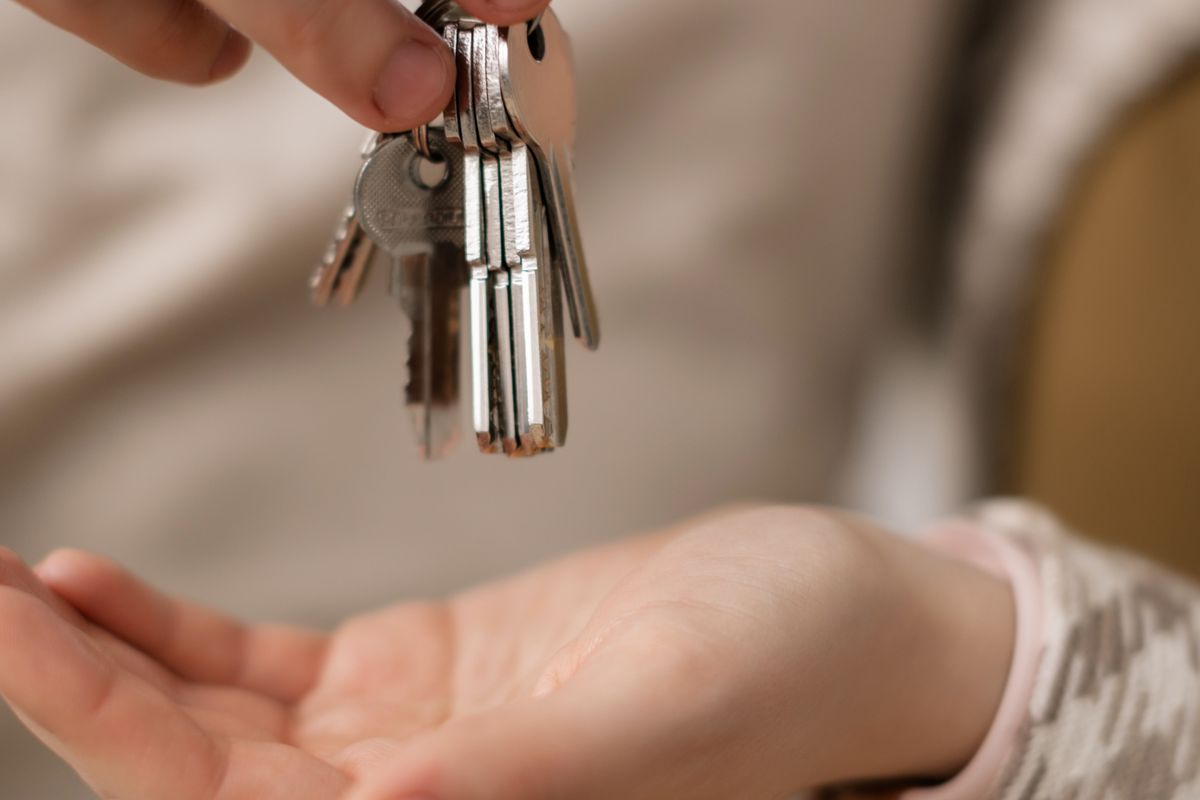 Hands passing a set of keys