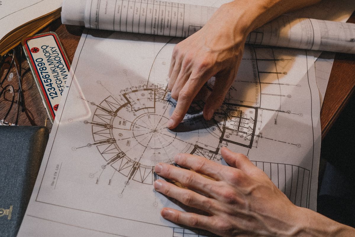 Hands checking drawings and project papers