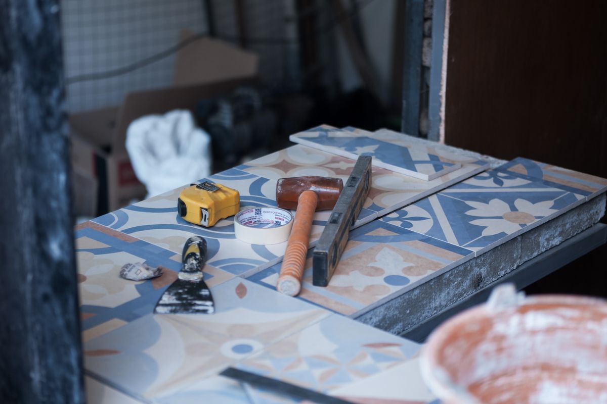 Tiling tools and materials arranged on a work surface