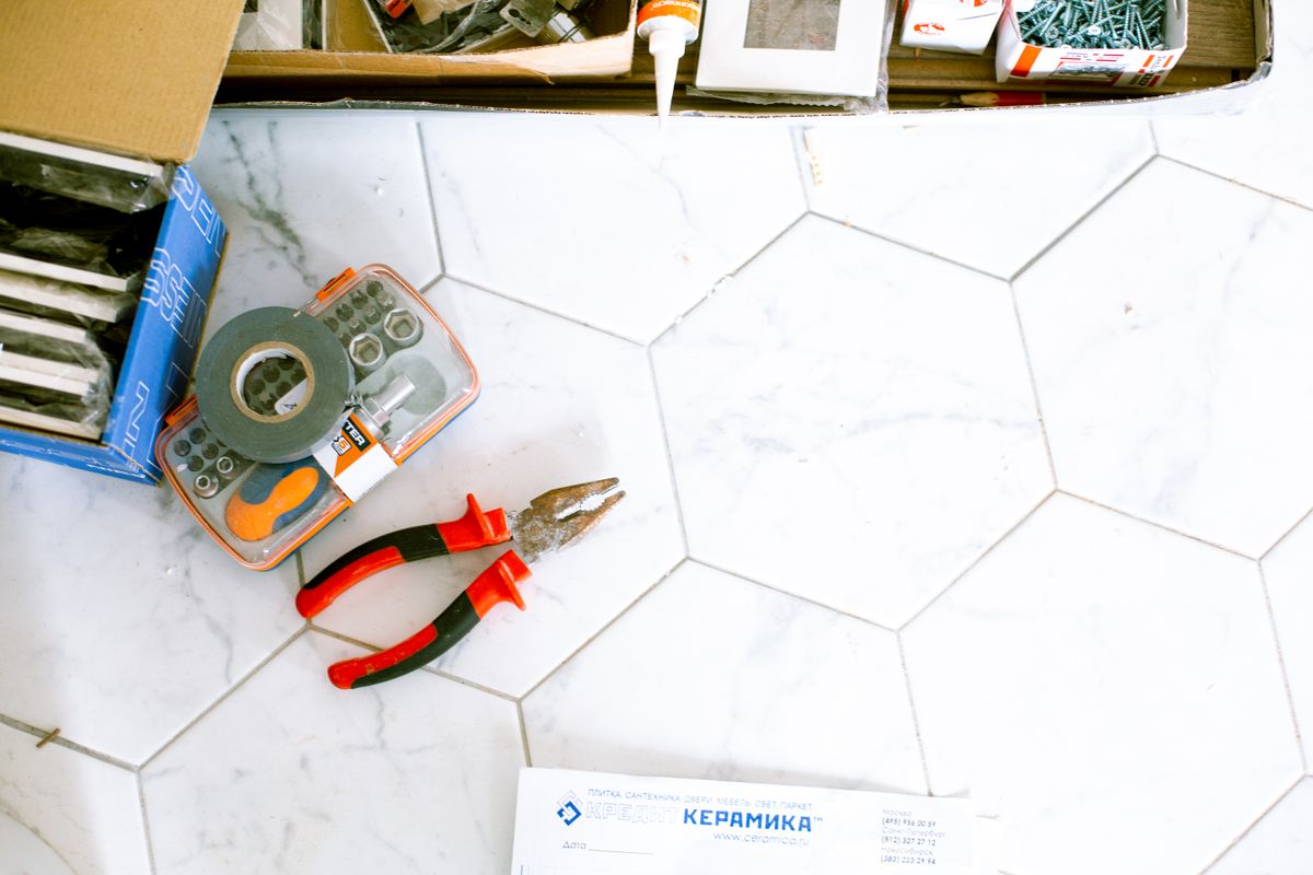 Renovation tools arranged on a tiled floor